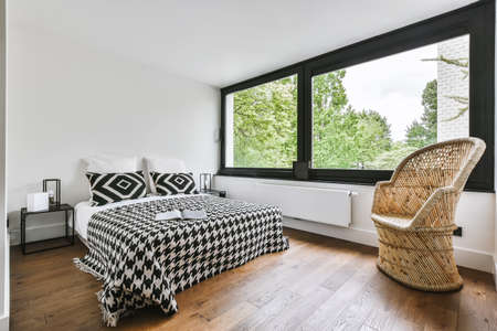 Stylish bedroom with a large window and a soft bed