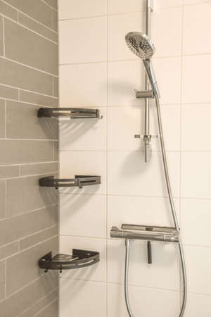 Classic modern bathroom with gray and white tiles in scandinavian style