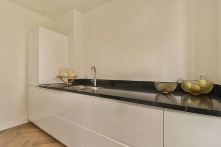 The interior of the kitchen in a modern style and white tones in a cozy apartment