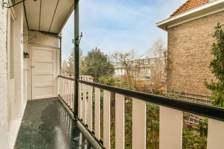 The balcony of a modern house with a view of the city street and natureの写真素材