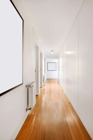A lovely long corridor in daylight with lots of doorsの写真素材