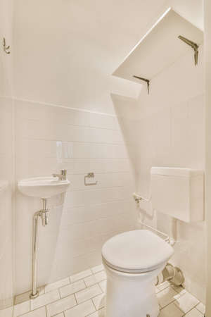 Modern white toilet with ceramic walls and tiles