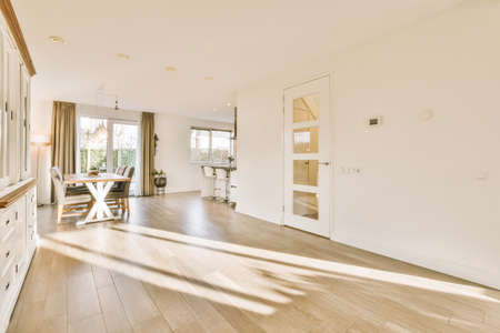 Bright home interior with table and way to kitchenの写真素材