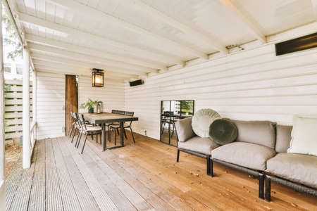 The interior of a cozy recreation area outside a residential building with wooden decorationの写真素材