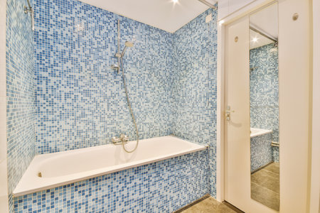 Small bedroom tiled with blue tiles in the form of a mosaic in a modern houseの写真素材