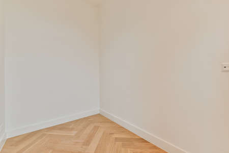 Spacious empty room with parquet floor in white in a modern house