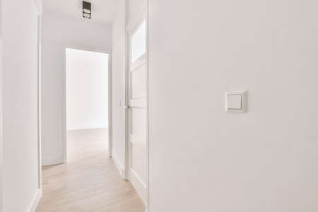 Spacious hallway interior with parquet floor and entrance to the cozy house