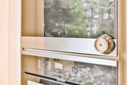 Modern kitchen oven close-up in a cozy houseの写真素材
