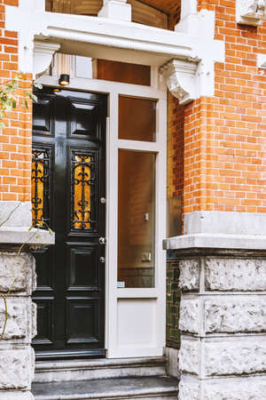 Entrance to a multi-storey residential brick house in European style