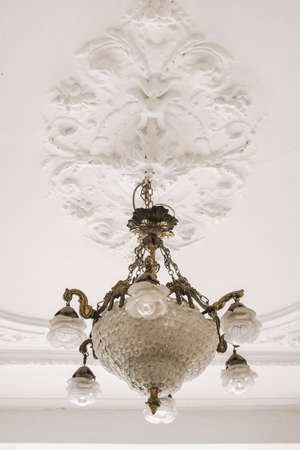 Chandelier in ceiling side with decoration partの写真素材