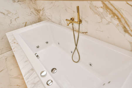 Marble bathroom with a ceramic bathtub in a modern house