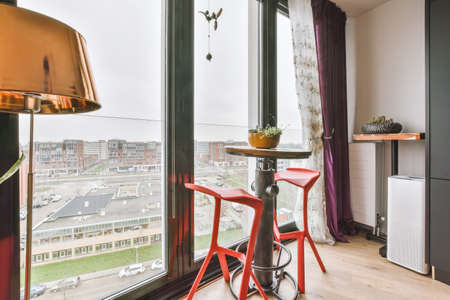 View from the panoramic window of a modern apartment on the city from the height of a multi-storey buildingの写真素材