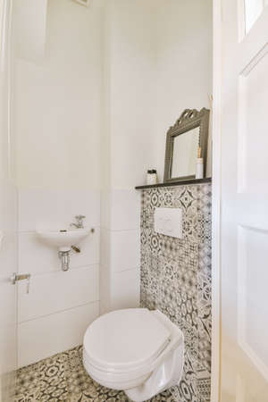 Interior of small clean restroom in miniature style