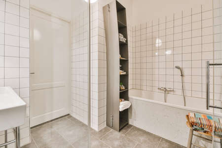 Sink with tap installed on tabletop near mirror and door in contemporary bathroom at home