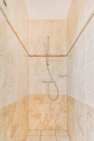 Bathroom interior finished with marble tiles with a shower cabin in a modern houseの写真素材