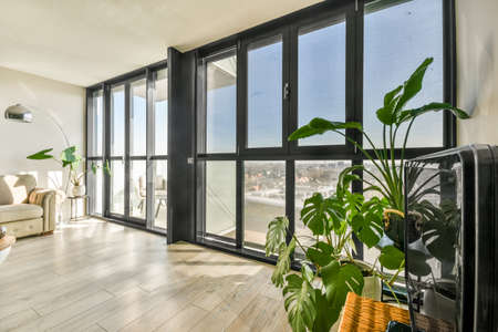 Contemporary minimalist style interior design of light studio apartment with wooden table and chairs...