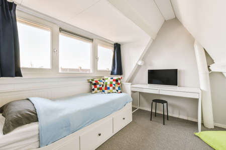 Home interior design of bedroom with bedtable,chair,computer and wooden wardrobe placed in corner...