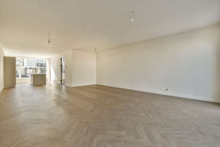 Interior of empty white kitchen with windows and wooden parquet floorの写真素材