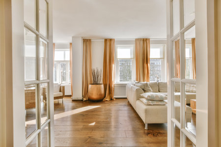 Stylish home interior design of spacious living room with large windows and white walls furnished...