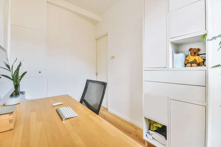 Background of minimal home office workplace in modern apartment decorated by plants