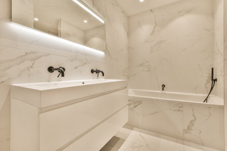 Sink with tap and liquid soap hanging on tiled wall under mirror in contemporary restroom at homeの写真素材