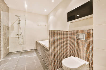 Stylish shower cabinet in a brown white tiled bathroom