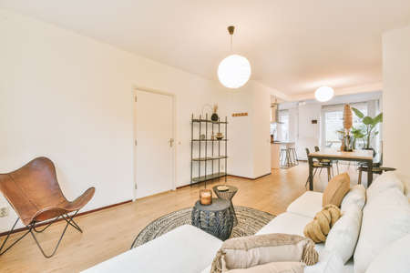 Stylish living-room with white sofa,white and brown pillows and decors
