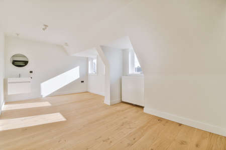 Plastic window and radiator on white wall in empty light room at home