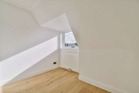 Plastic window and radiator on white wall in empty light room at homeの写真素材