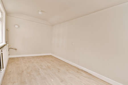 Plastic window and radiator on white wall in empty light room at homeの写真素材