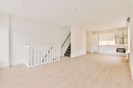 Interior of empty white kitchen with corridor and wooden parquet floor