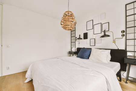 Stylish bedroom with the decorative frames on the wall