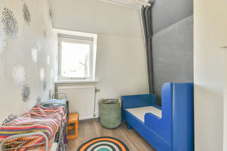 A spacious bright bedroom with a minimalistic stylish carpet and a large white window