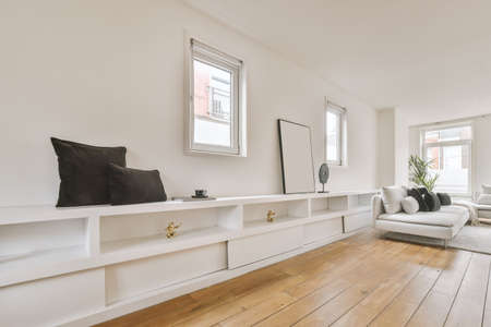 White wooden shelf on the wall and black pillows on it