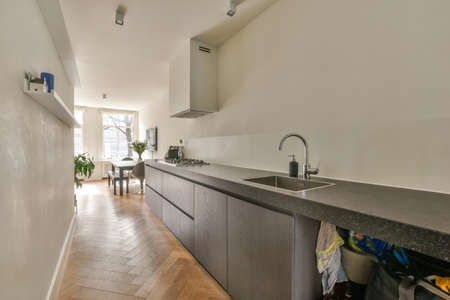 Spacious bright kitchen with white walls and tiled floorの写真素材