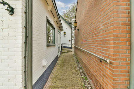 A narrow brick alley with a convenient handrail
