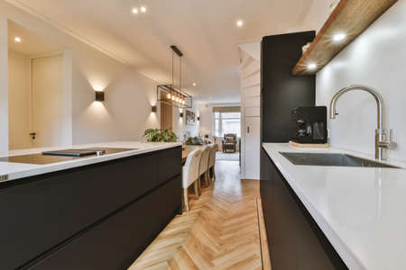 Modern minimalist style interior design of studio apartment with open black kitchen and dining zone...