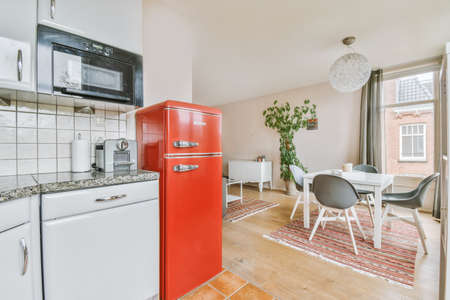 Home interior design of modern loft apartment with open kitchen in minimalist style and spacious...