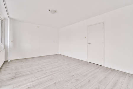 Interior of empty modern apartment with geometric design with entrance door and white walls and...