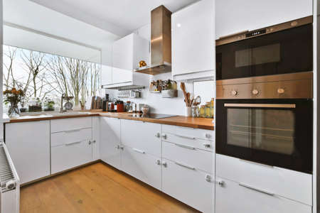 The interior of an amazing kitchen with a wooden countertop and a sink next to the window