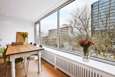 The interior of an amazing dining area next to a large window overlooking the streetの写真素材