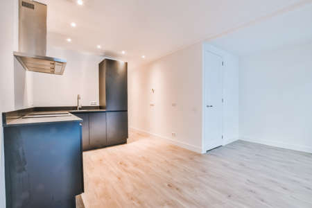 Luxurious kitchen interior with black kitchen set and parquet floor