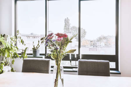The interior of a charming dining room with a wooden table next to the windowの写真素材