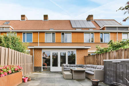 Delightful courtyard of the house with a soft sofa and a wicker table