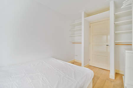 Attractive small bedroom with a soft bed and white walls