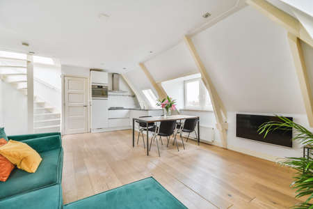 An attractive living room combined with a dining room with a black tableの写真素材