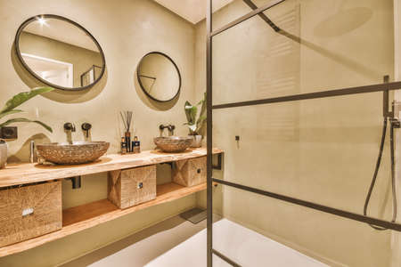 Sink base cabinet and mirror cabinet in white tiled bathroom with wall hung toilet