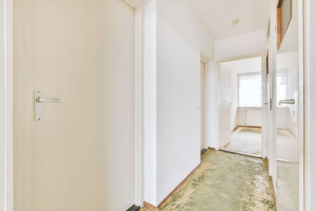 Plastic window and radiator on white wall in empty light room at home