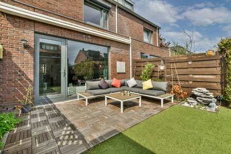 Minimalistic bright and landscaped backyard with dining area for outdoor recreationの写真素材