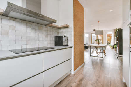 Counters with stove and oven located in modern kitchen near dining room at home